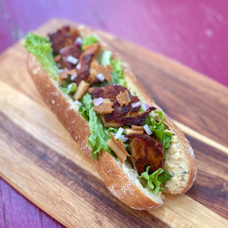 Not Chook baguette with garlic herb cheddar, lettuce and red onion